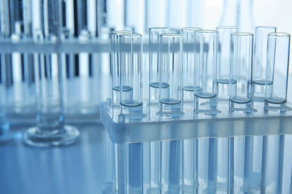 Test tubes with liquid in stand on table — Stock Photo, Image