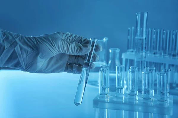 Scientist holding test tube with liquid in laboratory — Stock Photo, Image