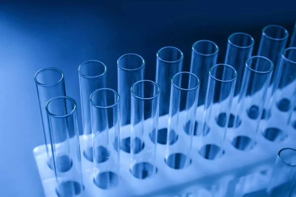 Test tubes in stand on dark background, closeup — Stock Photo, Image