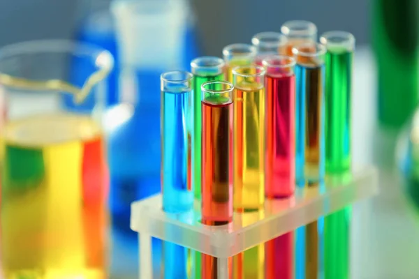 Test tubes with colorful samples in laboratory, closeup — Stock Photo, Image