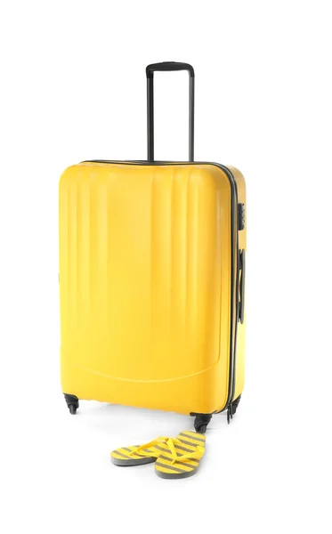 Large suitcase and flip-flops on white background — Stock Photo, Image
