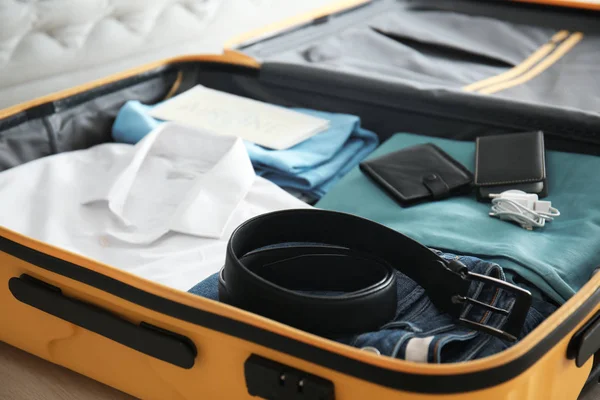 Open suitcase with packed things, closeup — Stock Photo, Image