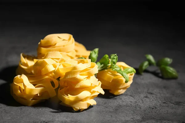 Uncooked fettuccine pasta on table — Stock Photo, Image