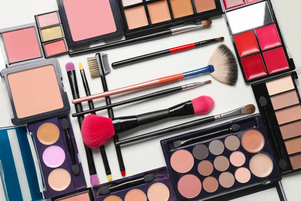 Set of decorative cosmetics and makeup brushes on white background — Stock Photo, Image