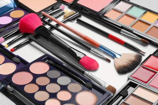 Set of decorative cosmetics and makeup brushes on white background — Stock Photo, Image