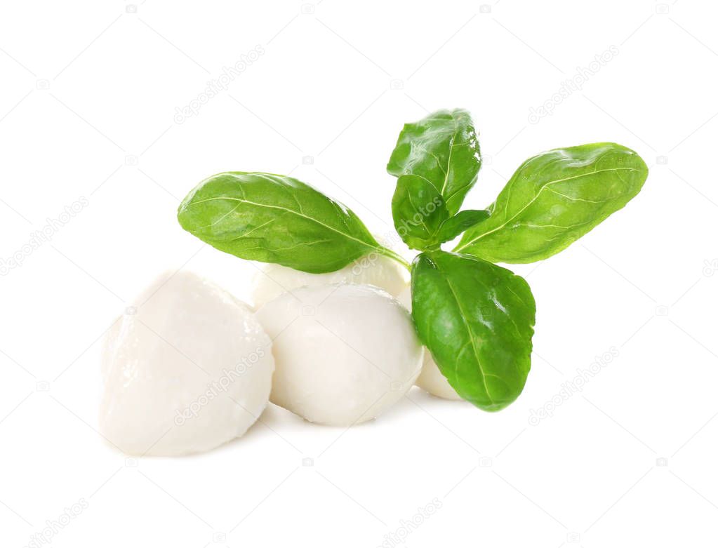 Mozzarella cheese balls and basil on white background