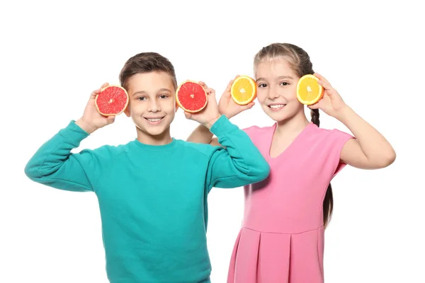 Funny little children with citrus fruits on white background — Stock Photo, Image