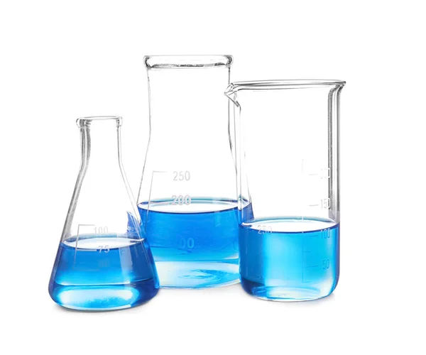 Laboratory glassware with blue liquid on white background — Stock Photo, Image