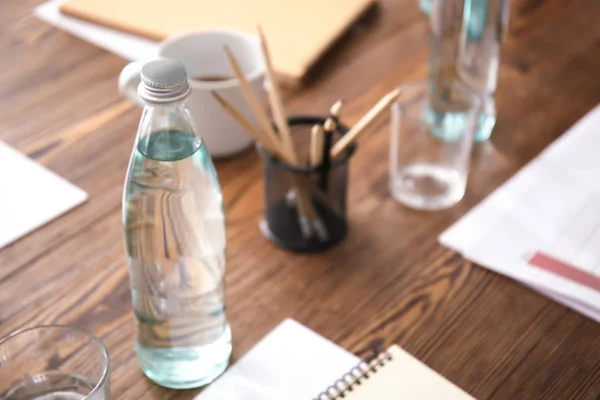 Table with bottle of water prepared for business meeting in conference hall