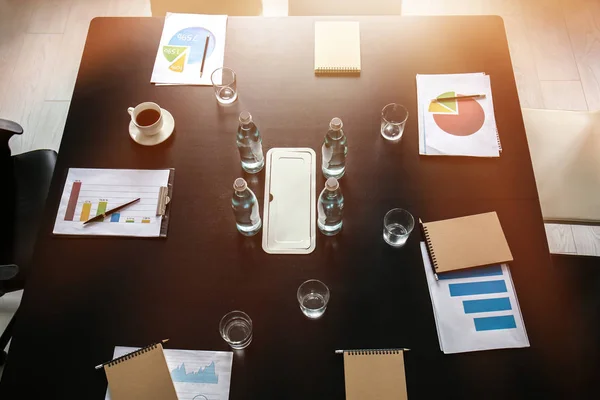 Table with documents and bottles of water prepared for business meeting