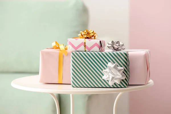 Elegant gift boxes on table indoors