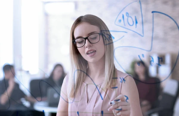 Young woman giving presentation during business meeting in office — Stock Photo, Image