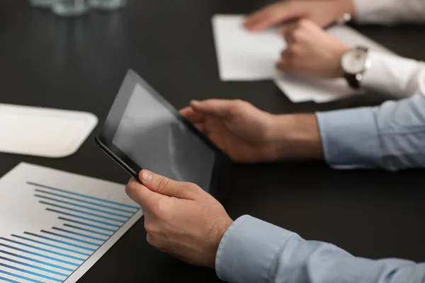 Young man with tablet at business meeting — Stock Photo, Image