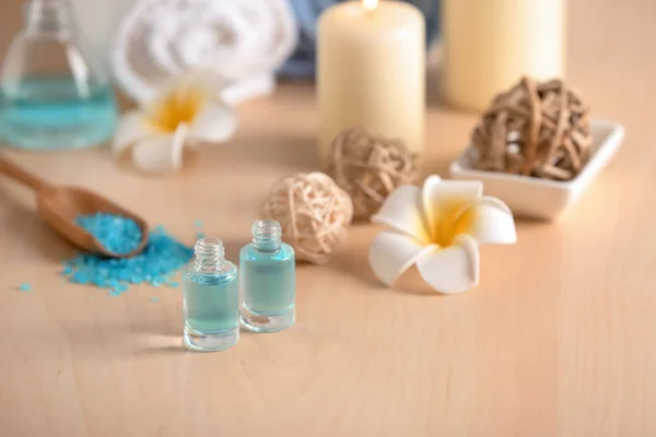 Bottles of essential oil for spa procedures on table — Stock Photo, Image