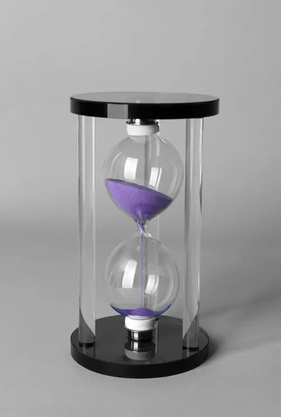 Hourglass on grey background. Time management concept — Stock Photo, Image