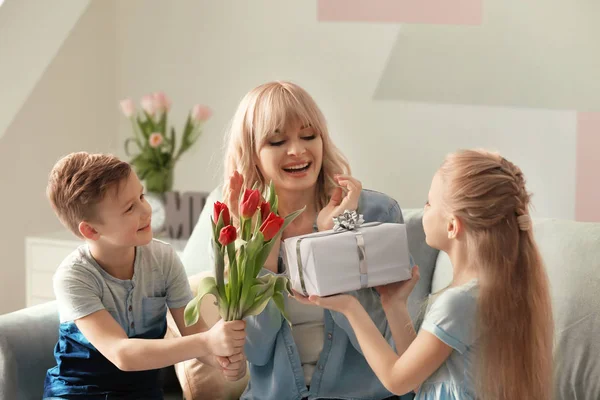 Cute little kids congratulating their mother at home — Stock Photo, Image