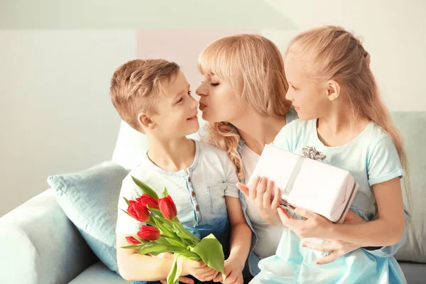 Cute little kids congratulating their mother at home — Stock Photo, Image