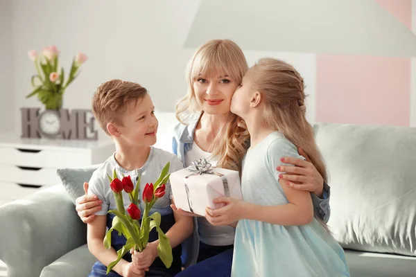 Cute little kids congratulating their mother at home — Stock Photo, Image