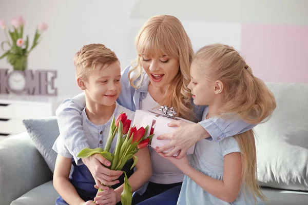 Cute little kids congratulating their mother at home — Stock Photo, Image