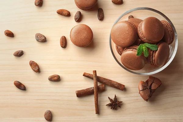 Flat lay composition with delicious chocolate macarons on table — Stock Photo, Image