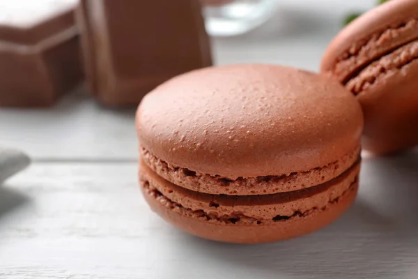 Delicious chocolate macarons on table — Stock Photo, Image