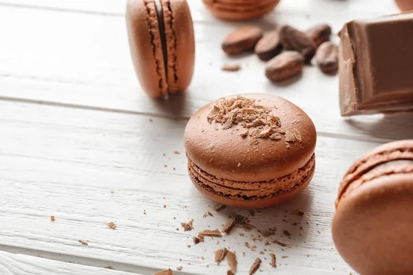 Delicious chocolate macarons on wooden background — Stock Photo, Image