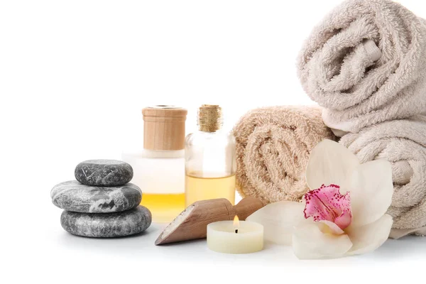 Spa composition with rolled towels and stones on white background — Stock Photo, Image