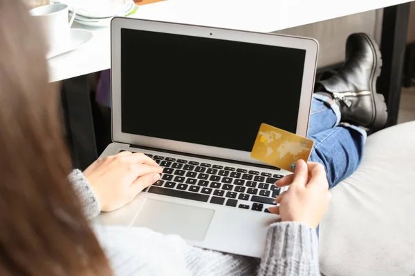 Young woman shopping online with credit card and laptop indoors — Stock Photo, Image