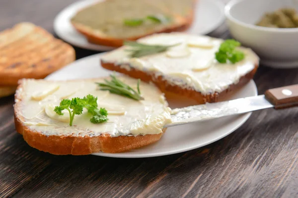 Tasty toasted bread with butter on plate — Stock Photo, Image