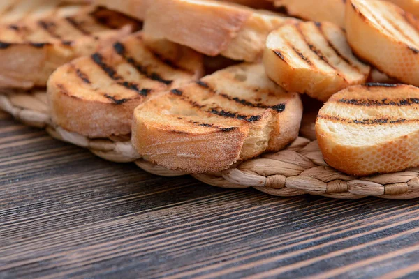 Tasty toasted bread on wooden table — Stock Photo, Image