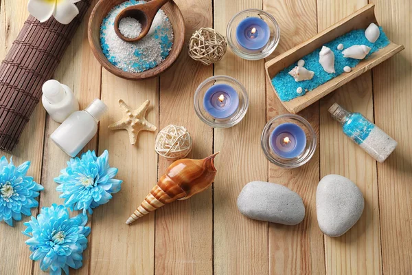 Beautiful spa composition with sea salt, flowers and candles on wooden background, top view — Stock Photo, Image