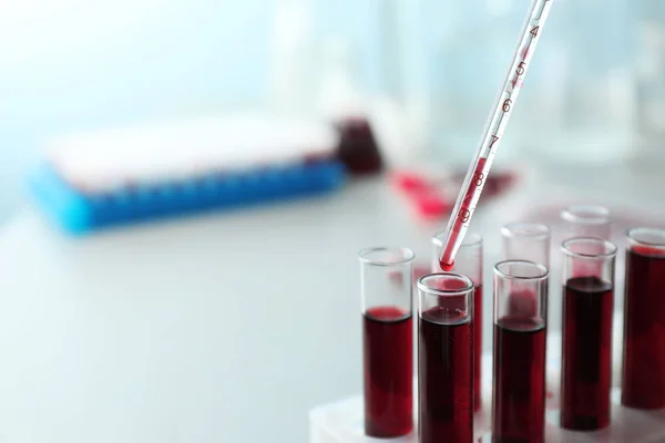 Dripping blood into test tubes, closeup — Stock Photo, Image