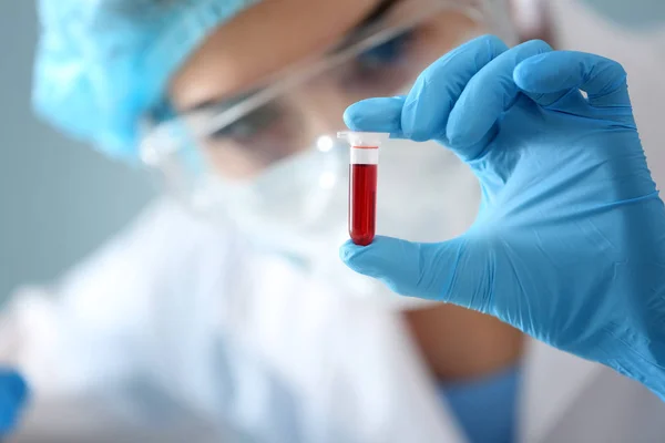 Woman holding test tube with blood sample, closeup — Stock Photo, Image