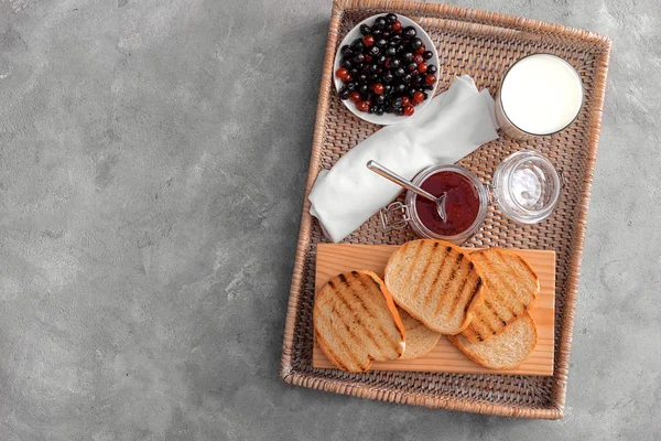 Tray with toasted bread and jam on grey background, top view — Stock Photo, Image