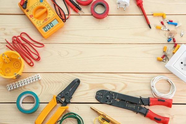 Flat lay composition with electrical tools on wooden background — Stock Photo, Image