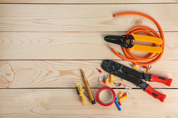 Flat lay composition with electrical tools on wooden background — Stock Photo, Image