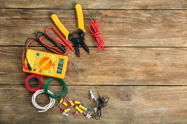 Flat lay composition with electrical tools on wooden background — Stock Photo, Image