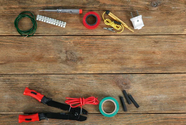 Flat lay composition with electrical tools on wooden background — Stock Photo, Image
