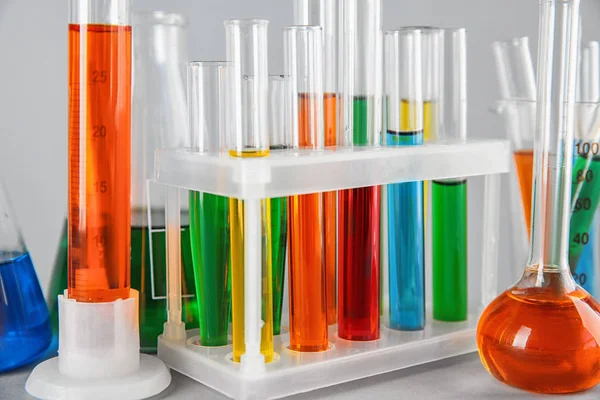 Test tubes with colorful liquids in holder, closeup — Stock Photo, Image