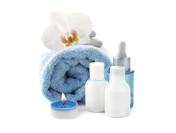 Beautiful spa composition with cosmetics, towel and burning candle on white background — Stock Photo, Image