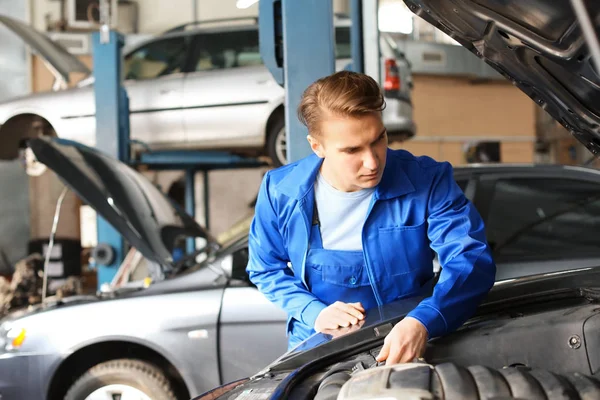Mechanik mężczyzna naprawianie samochodu w centrum obsługi — Zdjęcie stockowe