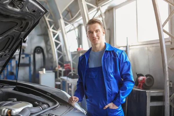 Retrato de mecánico masculino cerca del coche en el centro de servicio — Foto de Stock