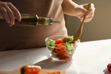 Tablo taze sebze salata bir kase içine zeytinyağı ekleyerek kadın