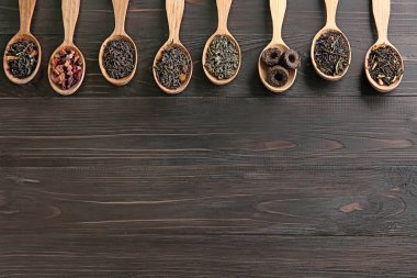 Düz ahşap zemin üzerine kaşık çay farklı türde, lay