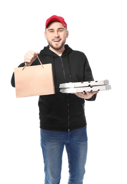 Young man with cardboard pizza boxes and paper bag on white background. Food delivery service — Stock Photo, Image