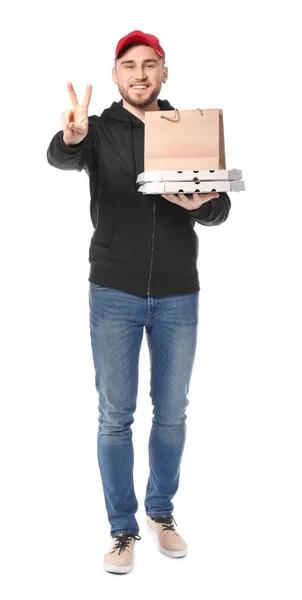 Young man with cardboard pizza boxes and paper bag on white background. Food delivery service — Stock Photo, Image