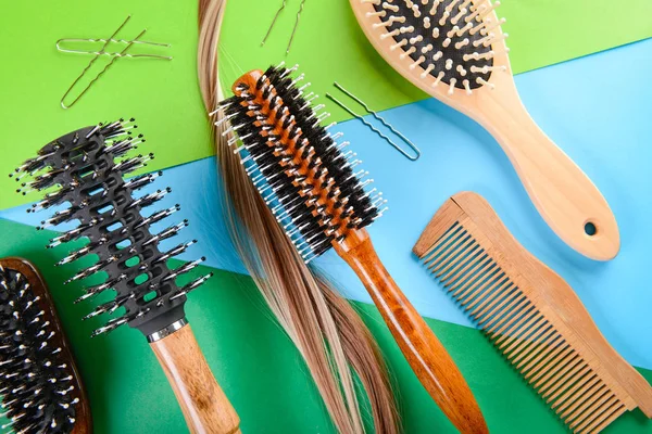 Flat lay composition with hairdresser's tools and strand of hair on color background — Stock Photo, Image