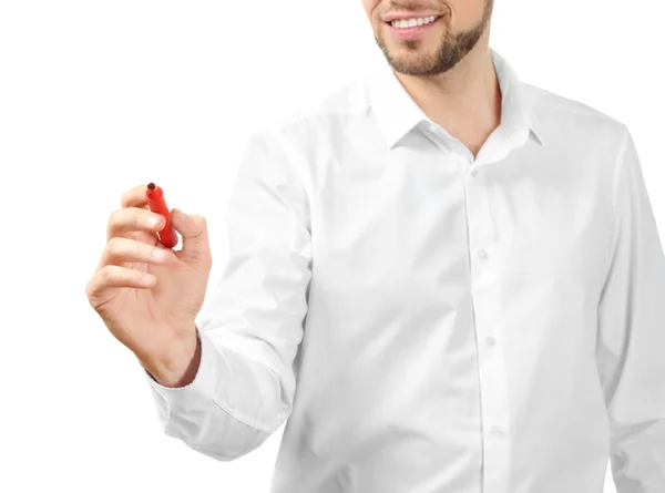 Young businessman writing on virtual screen against white background — Stock Photo, Image