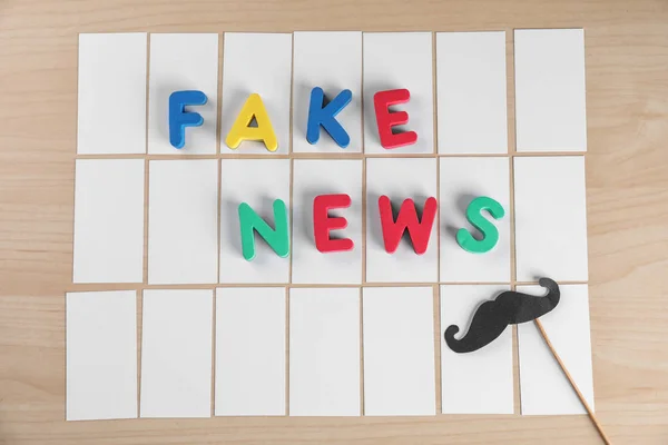 Phrase FAKE NEWS made with color letters on paper cards — Stock Photo, Image