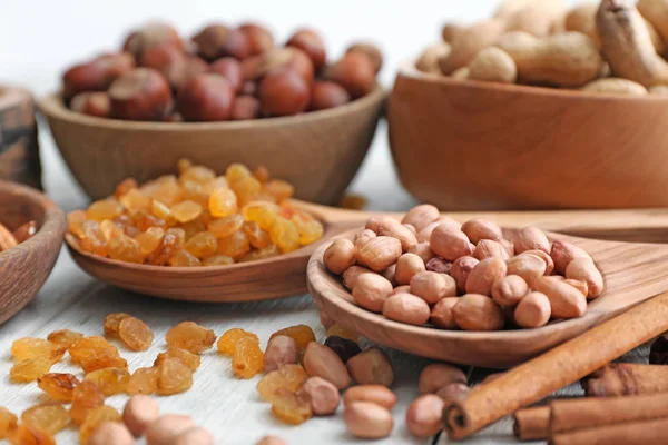 Verschillende soorten noten en rozijnen op tafel, close-up — Stockfoto